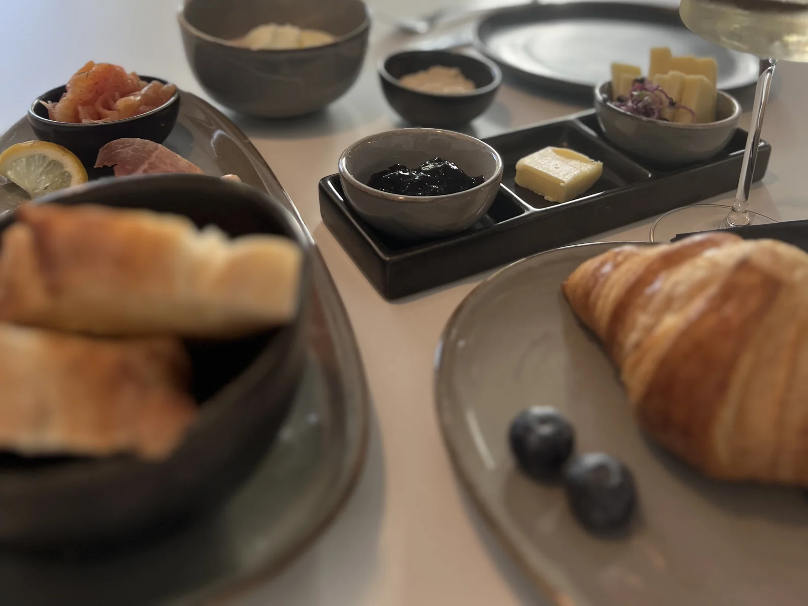 Breakfast at a window table at Pförtnerhaus: croissant, butter and jam